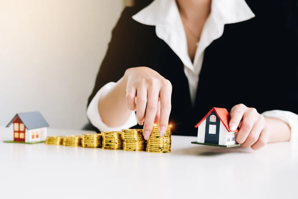 businesswoman is holding house models and coins co 2023 11 27 05 10 23 utc